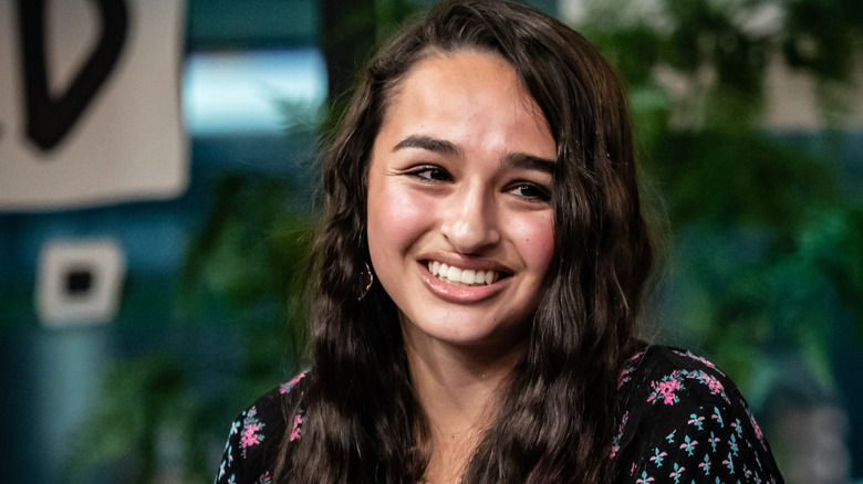 Jazz Jennings smiling while looking at someone