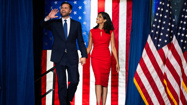 Usha Vance and JD Vance holding hands as they walk onto stage