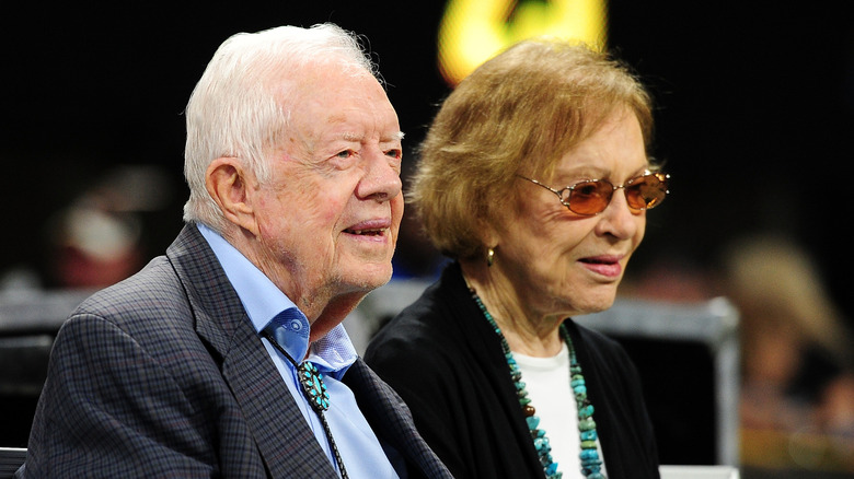 Elderly Jimmy and Rosalynn Carter smiling sitting together