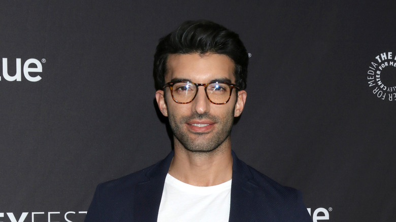 Justin Baldoni posing in glasses