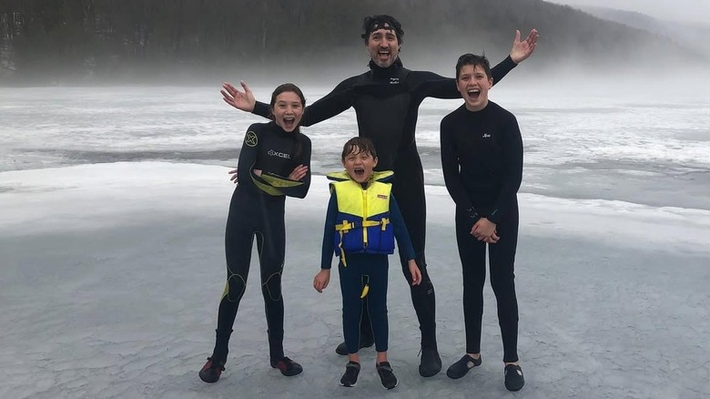 Justin Trudeau poses near water with his three kids