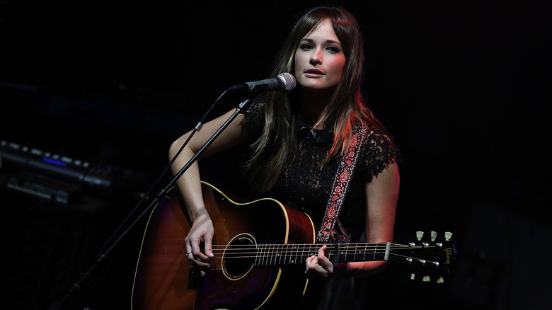 Kacey Musgraves performing with guitar