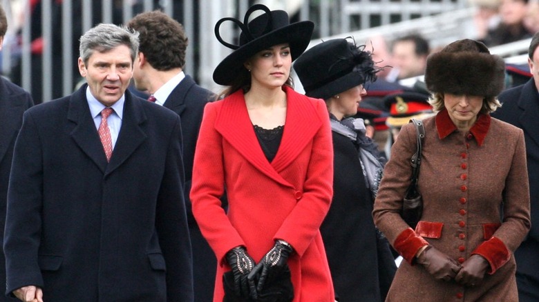 Michael, Catherine, and Carole Middleton walking in hats and coats