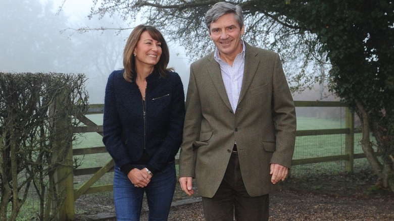 Carole and Michael walking outside during press interview