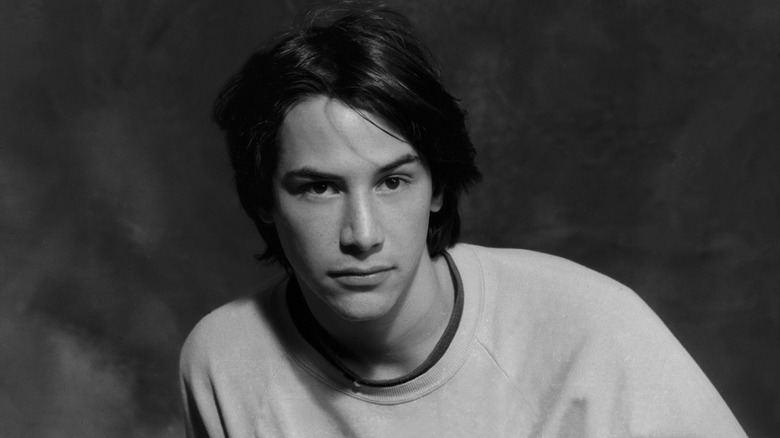 Young Keanu Reeves posing for a portrait in 1989