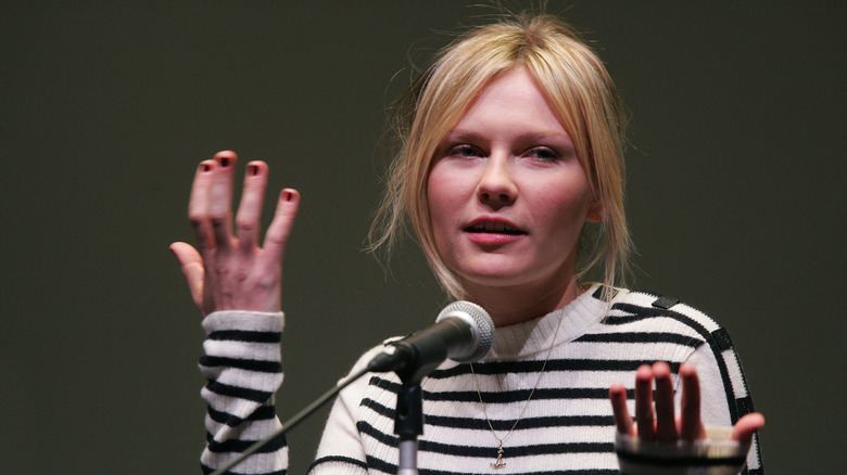 Kirsten Dunst talking into a microphone