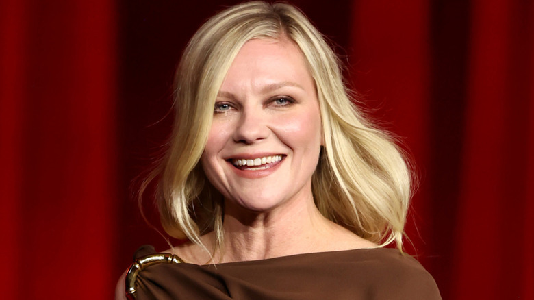 Kirsten Dunst smiling at an event