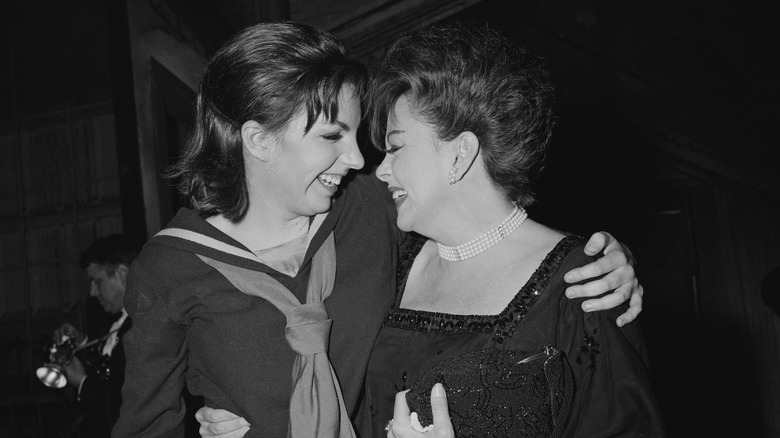 Liza Minnelli and Judy Garland laughing and embracing