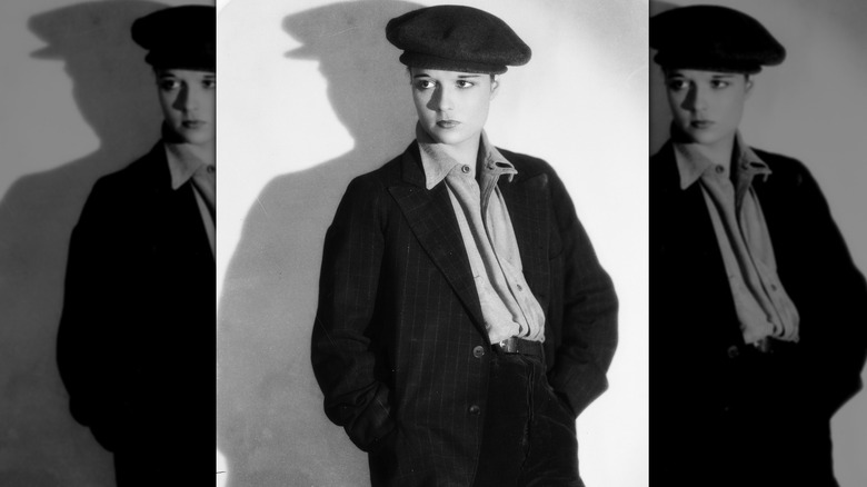 Louise Brooks poses in a suit and hat 