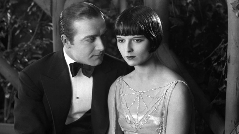 Louise Brooks with male co-star on film set