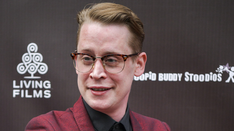 Macaulay Culkin smiling on red carpet