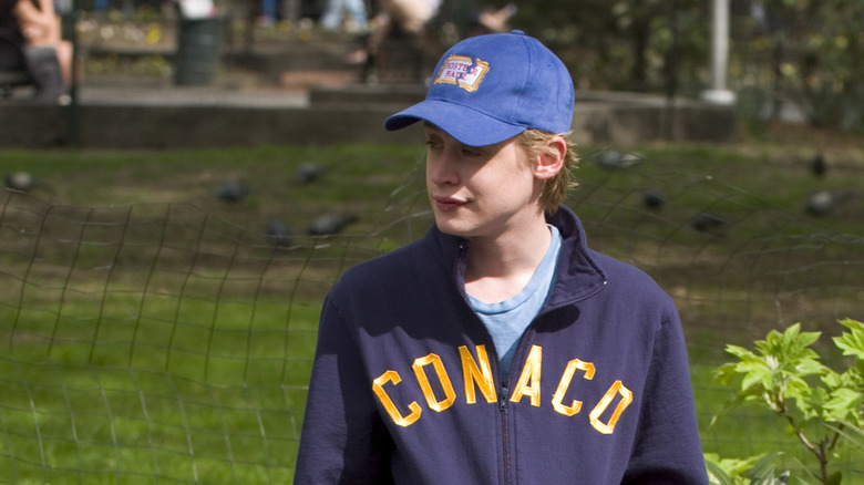 Macaulay Culkin  standing on the street