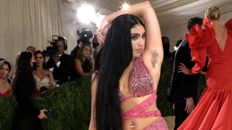 Lourdes Leon posing and showing off her underarm hair in a pink sparkly gown at the Met Gala in September 2021