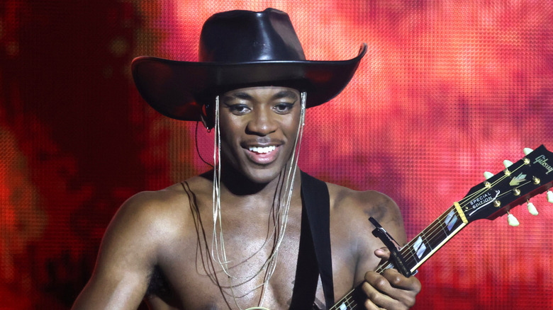 David Bandas smiling while holding guitar