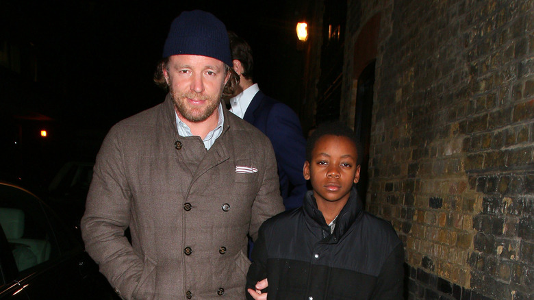 Guy Ritchie and young David Banda walking together