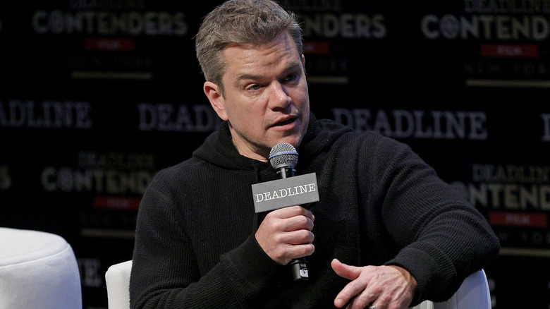 Matt Damon speaking into a microphone