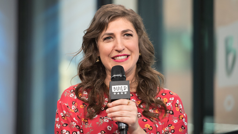 Mayim Bialik speaking into microphone