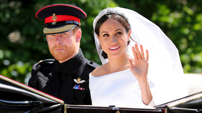 Prince Harry and Meghan Markle waving