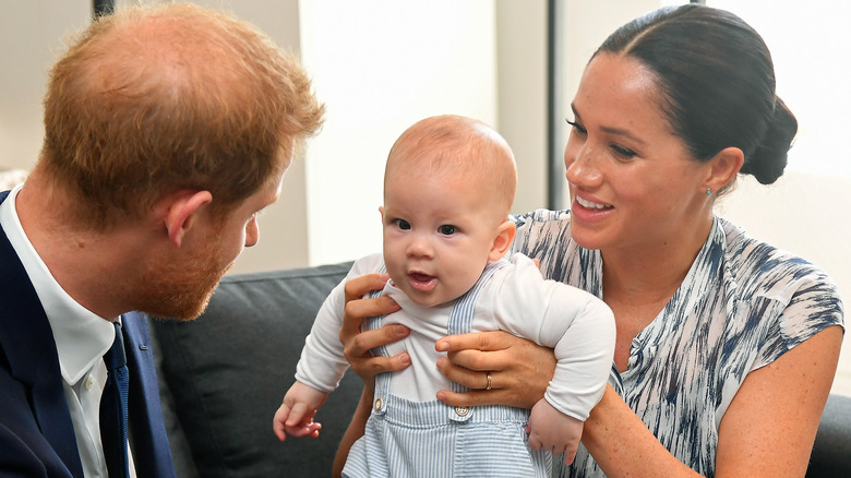 Prince Harry and Meghan Markle holding their son, Archie 