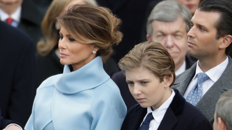 Melania Trump and Barron Trump standing next to each other