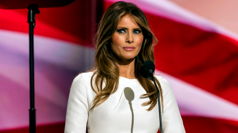 Melania Trump frowning in front of microphone