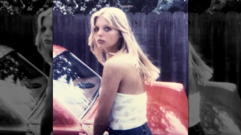 Young Michelle Pfeiffer with a red car