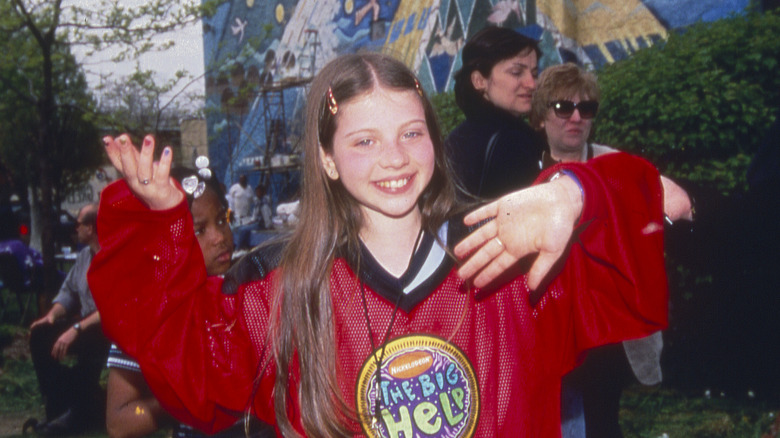 Michelle Trachtenberg waving and smiling