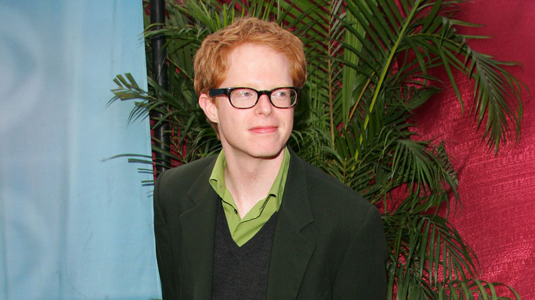 Young Jesse Tyler Ferguson wearing glasses