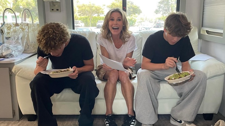 Julie Bowen sitting between 2 of her sons