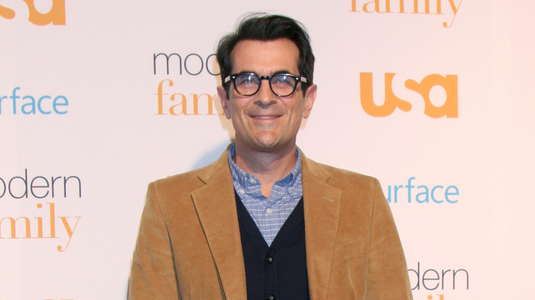 Ty Burrell smiling wearing glasses