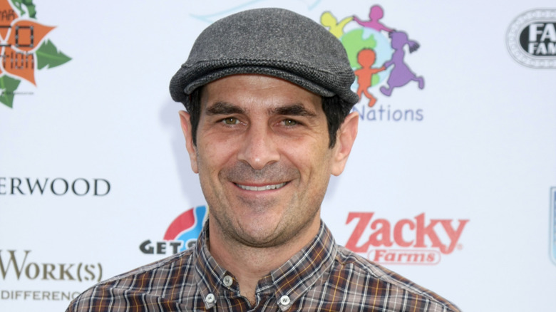 Ty Burrell wearing a hat and smiling