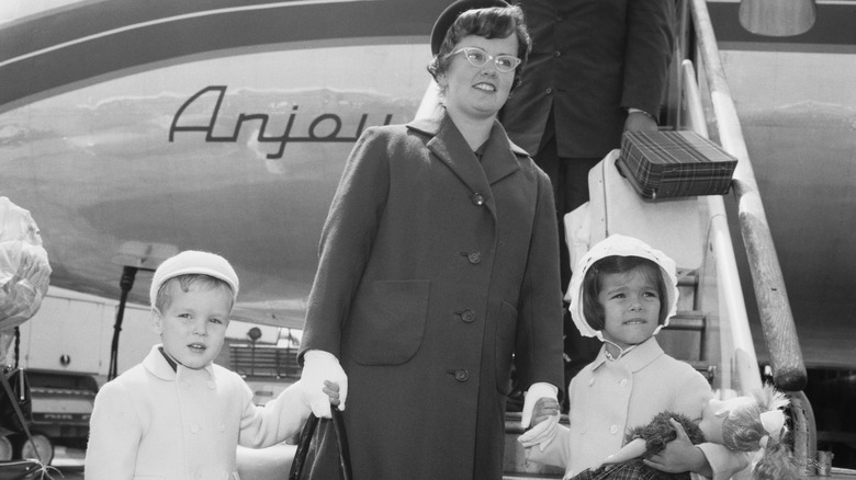 Prince Albert, their nanny, Princess Caroline, walking off plane