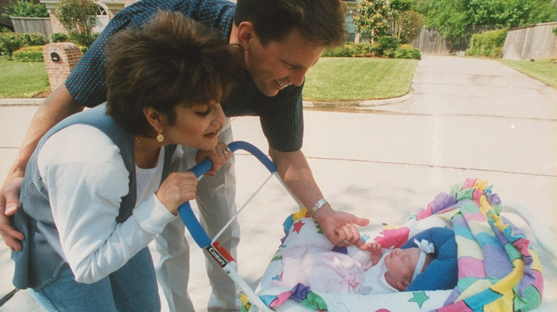 Mary Lou Retton and Shannon Kelley looking at their daughter in a stroller