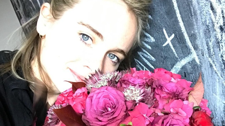 Cressida Bonas with a bouquet of flowers