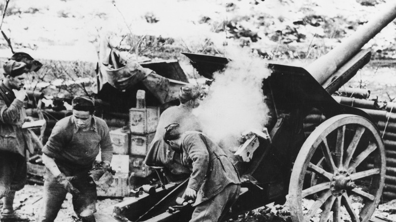 Soldiers firing a cannon