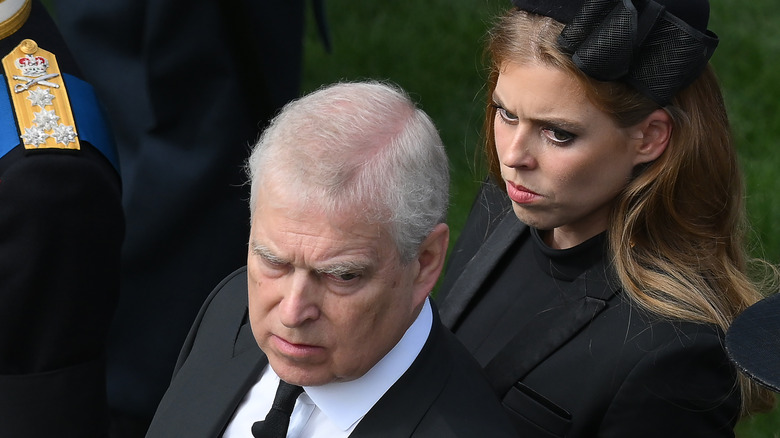 Princess Beatrice standing behind Prince Andrew