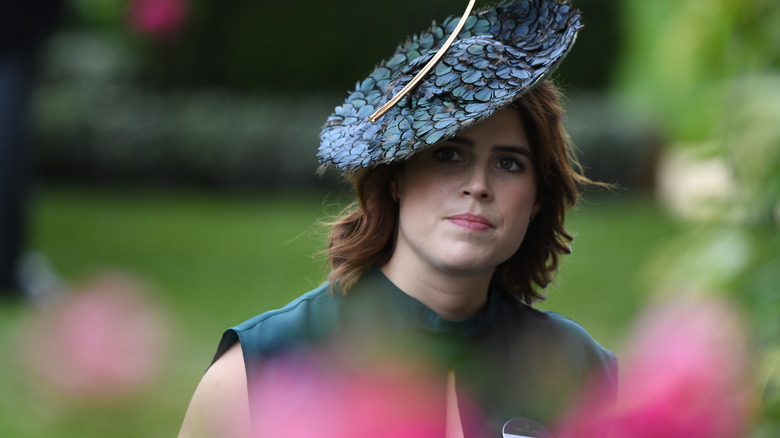 Princess Eugenie glancing from underneath her hat