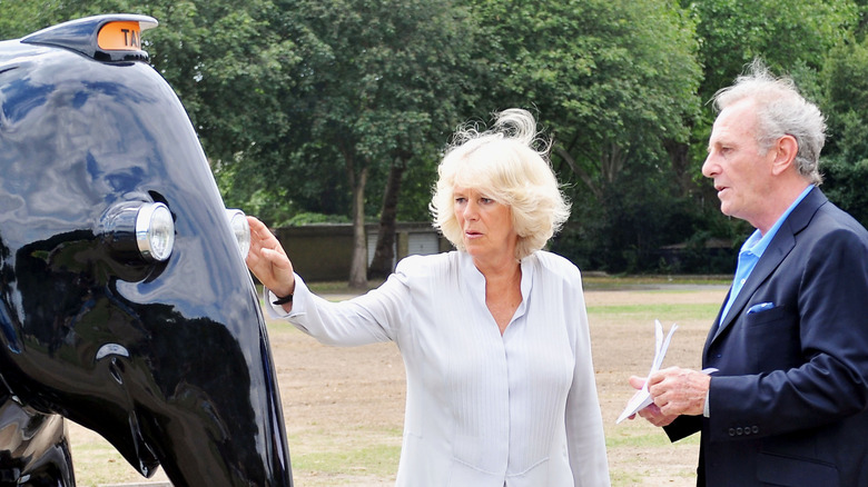 Camilla with Mark Shand by elephant statue