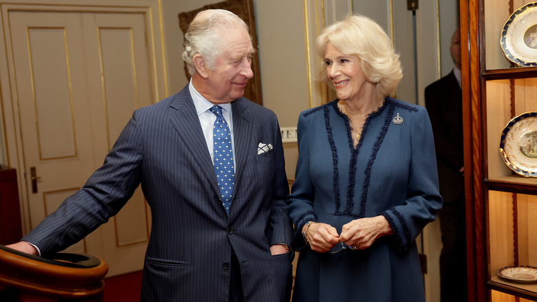 Charles and Camilla smiling at each other