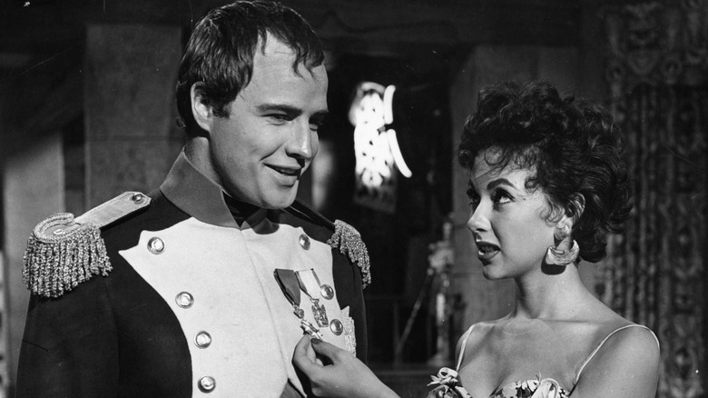 Rita Moreno and Marlon Brando posing 