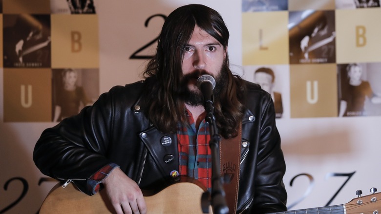 Indio Falconer Downey singing and playing guitar