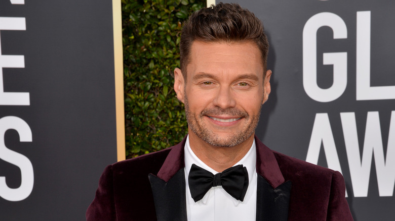 Ryan Seacrest posing on a red carpet