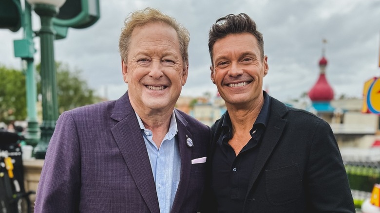 Sam Rubin and Ryan Seacrest smiling at Disneyland