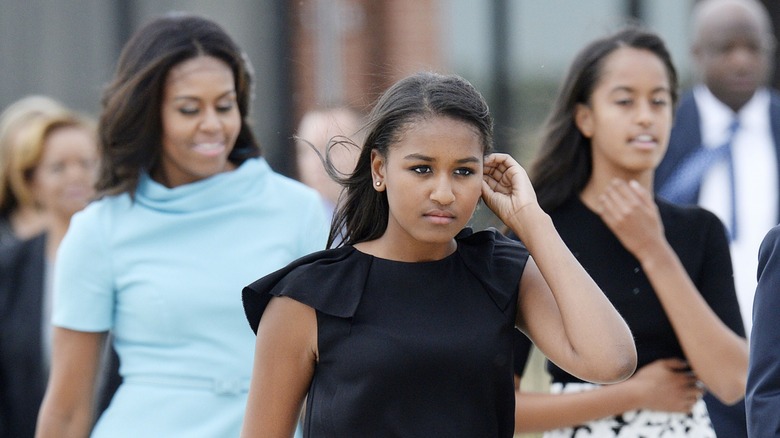 Sasha Obama with Malia Obama and Michelle Obama walking