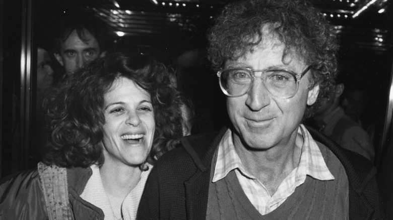 Gilda Radner with Gene Wilder smiling leaving a theater