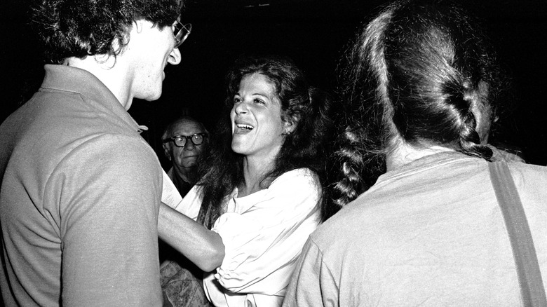 Gilda Radner laughing with man in crowd