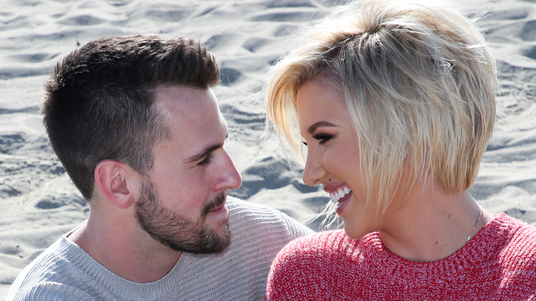 Savannah Chrisley and Nic Kerdiles smiling at each other