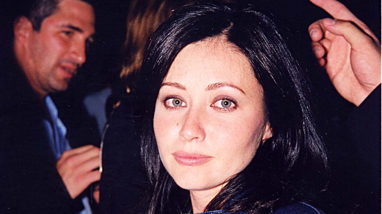 Shannen Doherty smiling with Dean Factor in background