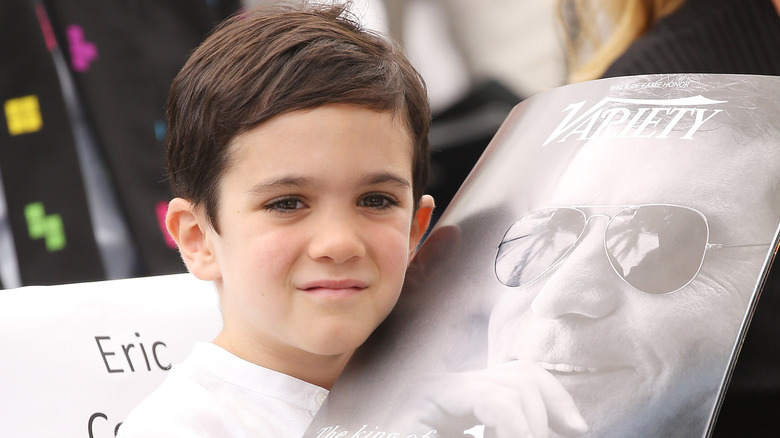 Eric Cowell posting with issue of Variety featuring dad Simon Cowell