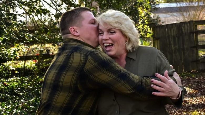 Garrison Brown kisses a smiling Janelle Brown on the cheek